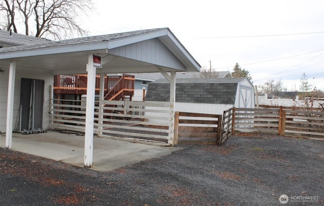 entrance to property with fence and roof with shingles