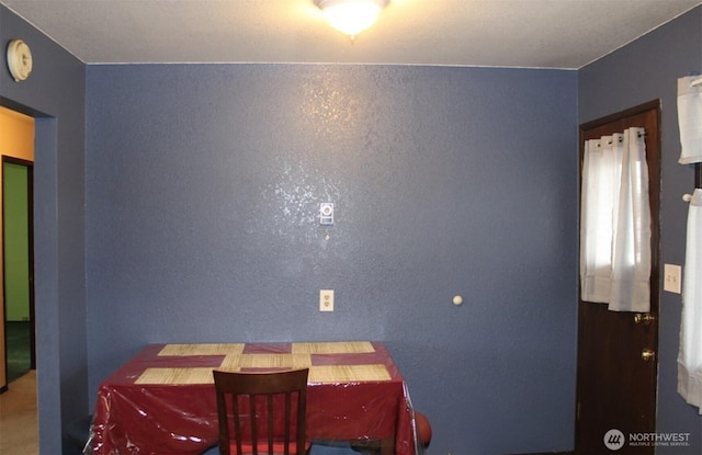 dining room featuring a textured wall