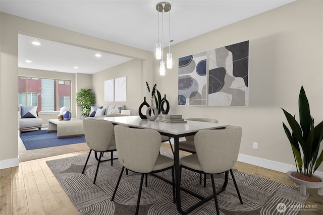 dining room with recessed lighting, wood finished floors, and baseboards