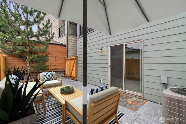 wooden terrace featuring fence, an outdoor hangout area, central AC, and a patio