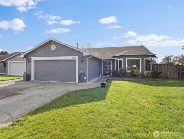 single story home with a garage, fence, a front lawn, and concrete driveway