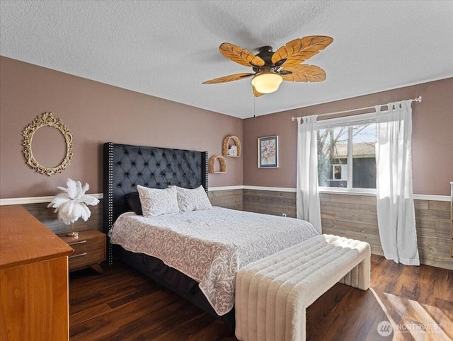 bedroom featuring ceiling fan, a textured ceiling, and wood finished floors