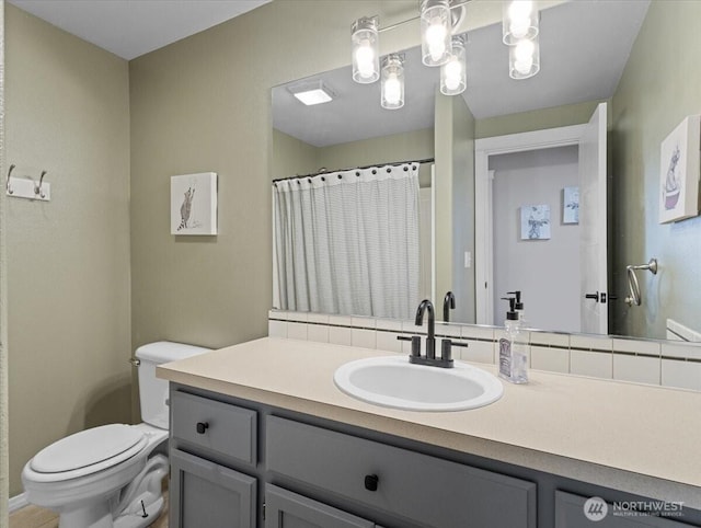 full bath featuring curtained shower, vanity, and toilet