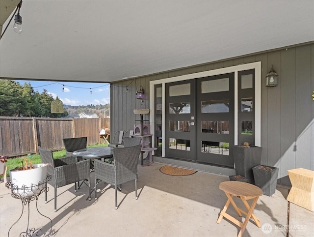 view of patio / terrace featuring fence, outdoor dining area, and french doors