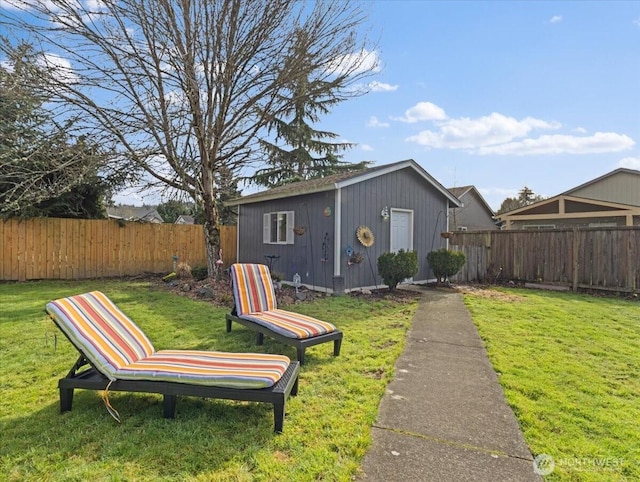 back of property featuring an outbuilding, a fenced backyard, and a yard