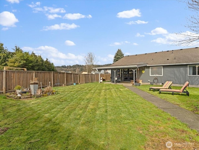 view of yard with a patio area and a fenced backyard