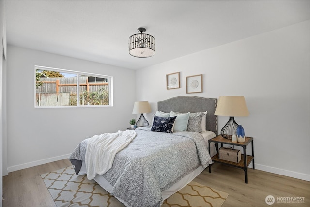 bedroom featuring wood finished floors and baseboards