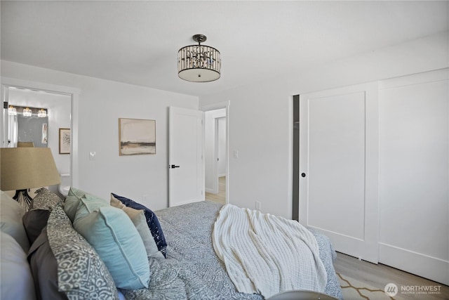 bedroom with a closet and light wood-style flooring