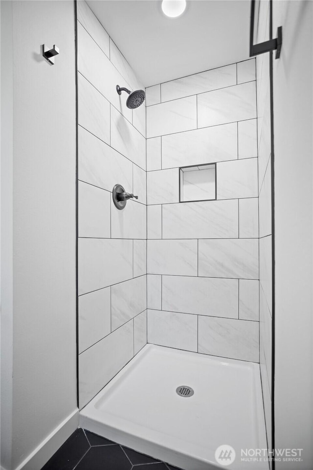 full bath featuring a tile shower