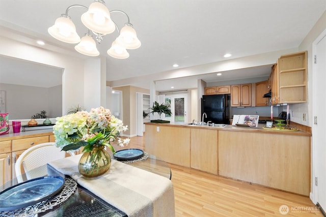 kitchen featuring freestanding refrigerator, a peninsula, light wood-type flooring, open shelves, and recessed lighting