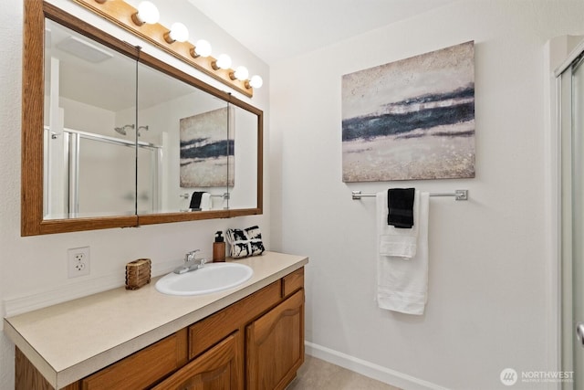 full bathroom featuring a stall shower, vanity, and baseboards