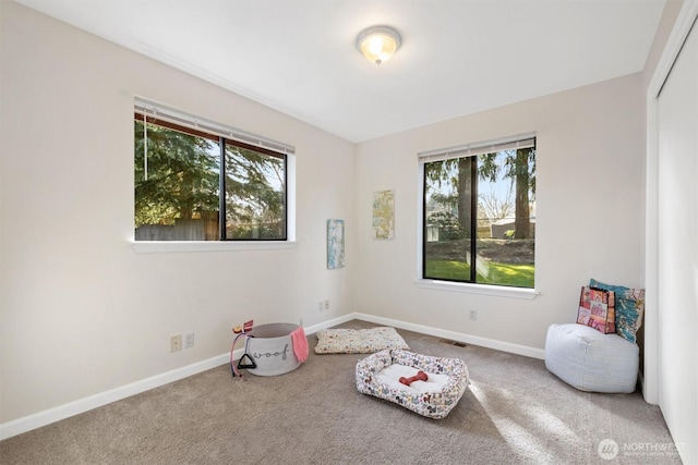 misc room with carpet floors, visible vents, and baseboards