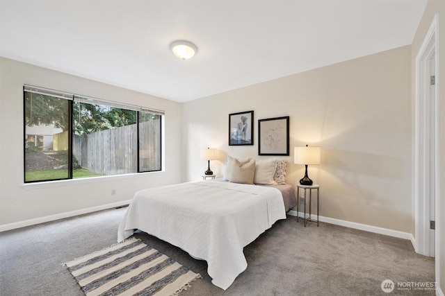 bedroom featuring carpet and baseboards