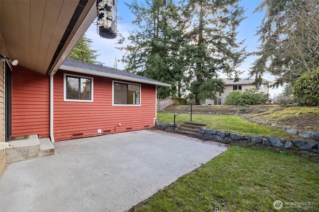 view of property exterior featuring a yard, crawl space, a patio area, and fence