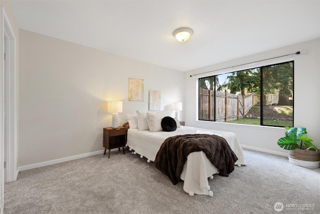 carpeted bedroom featuring baseboards