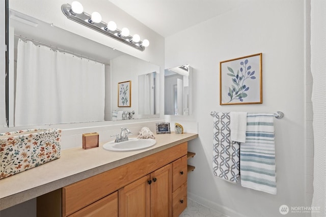 bathroom featuring baseboards and vanity