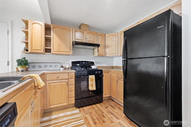 kitchen featuring under cabinet range hood, open shelves, light wood-style floors, light brown cabinetry, and black appliances