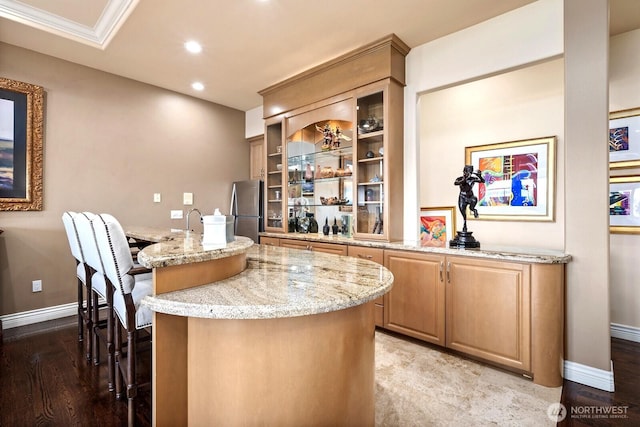 bar with baseboards, light wood finished floors, freestanding refrigerator, and recessed lighting