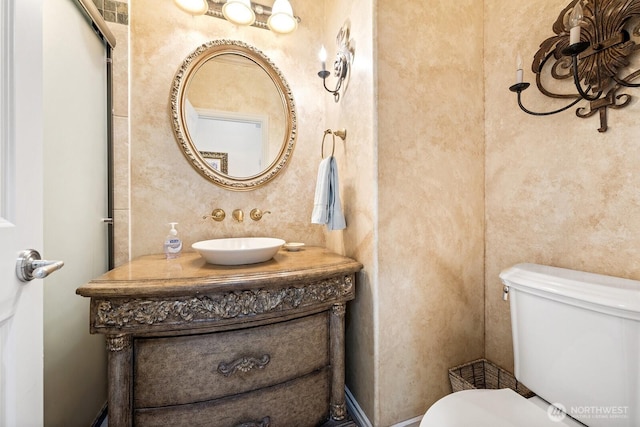 half bathroom featuring visible vents, vanity, and toilet