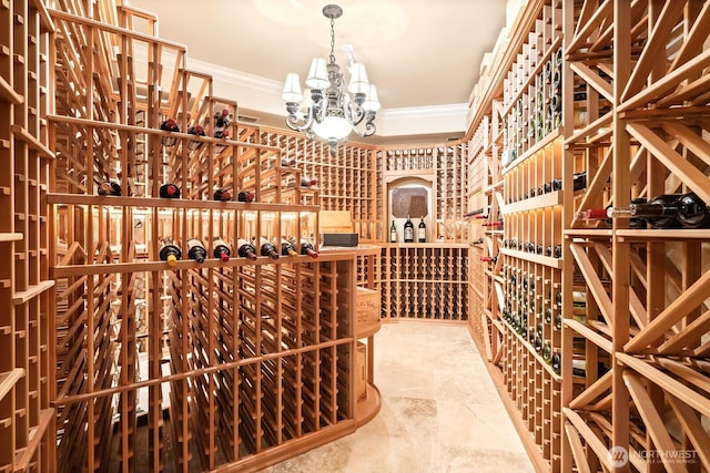 wine cellar featuring stone finish flooring, ornamental molding, and a chandelier