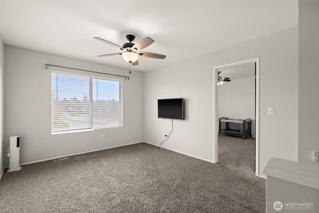 unfurnished living room featuring baseboards, a ceiling fan, and carpet