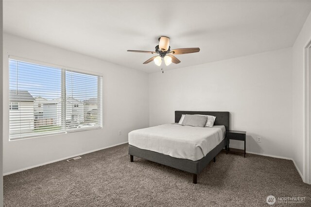 bedroom with visible vents, baseboards, carpet, and a ceiling fan