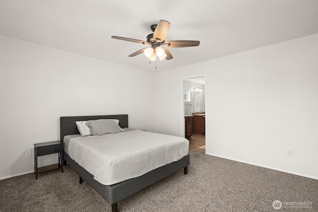 carpeted bedroom with a ceiling fan, baseboards, and ensuite bathroom