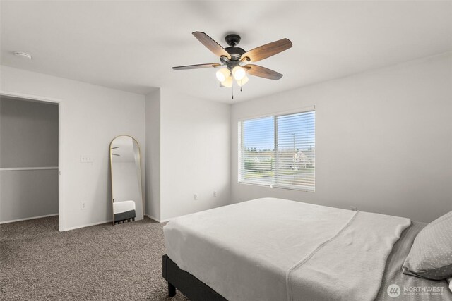 carpeted bedroom featuring baseboards and ceiling fan