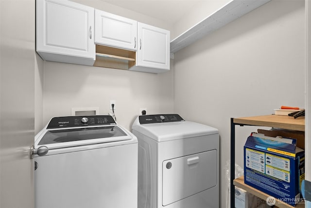 laundry room featuring cabinet space and washing machine and dryer