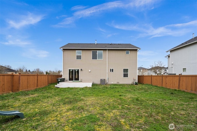 back of property with a yard, central air condition unit, and a fenced backyard