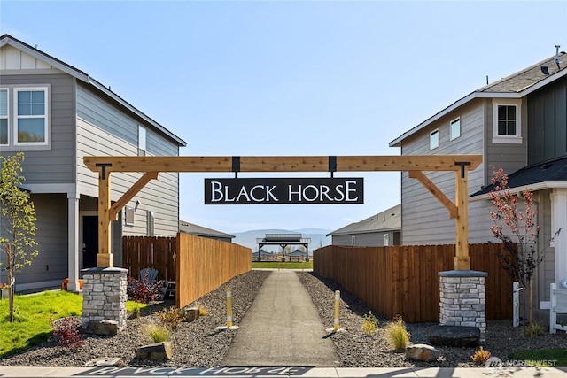 view of home's exterior with board and batten siding and fence