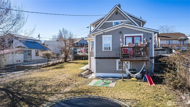 back of house with a yard and fence