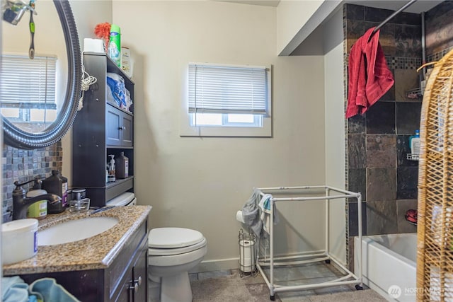 bathroom featuring toilet, bathing tub / shower combination, baseboards, and vanity