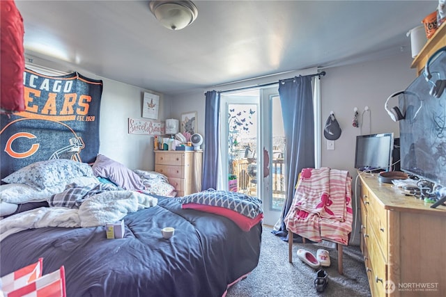 carpeted bedroom featuring access to exterior