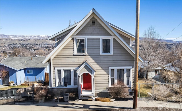 view of front of property featuring fence and a mountain view