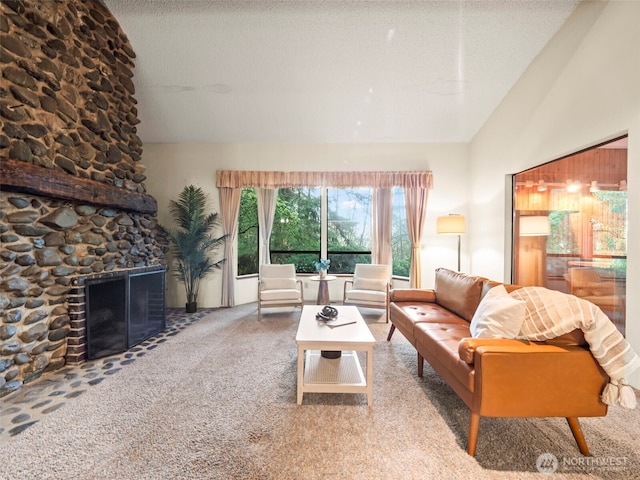 living area with lofted ceiling, a textured ceiling, a fireplace, and carpet flooring