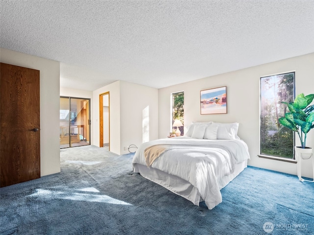 bedroom featuring a textured ceiling and carpet floors