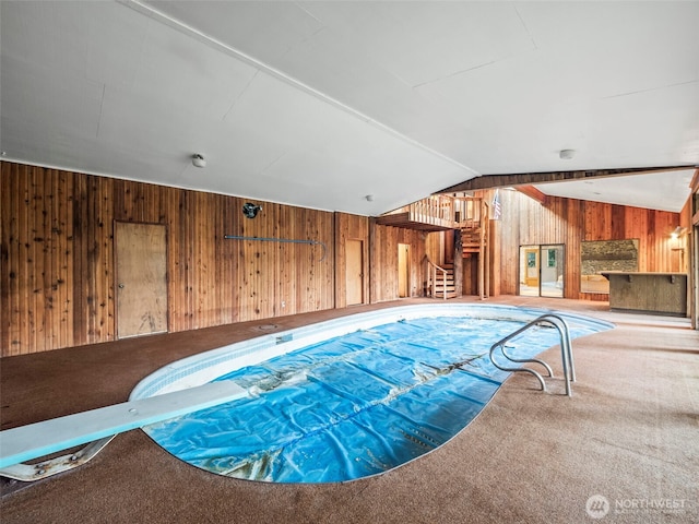 view of swimming pool with a diving board and a covered pool