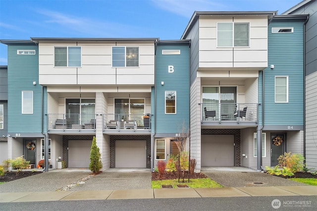 multi unit property featuring a garage and driveway