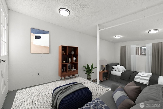 living room featuring a textured ceiling and a textured wall