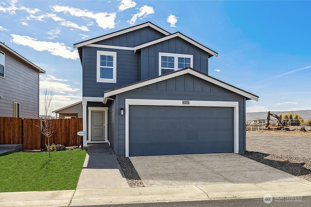 view of front of property with concrete driveway, board and batten siding, an attached garage, and fence