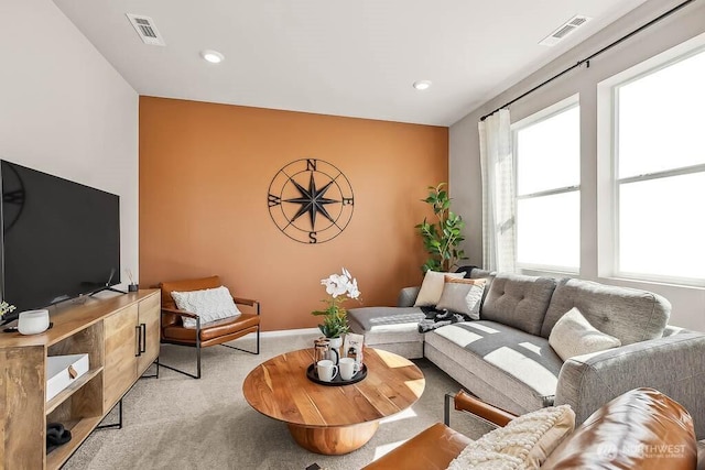 living room featuring light carpet, baseboards, visible vents, and recessed lighting