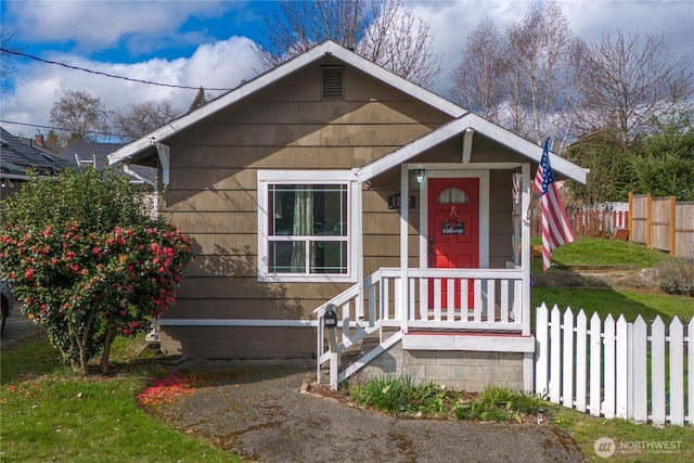 view of front of home featuring fence