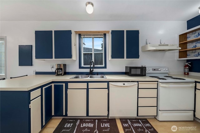 kitchen with a sink, a peninsula, blue cabinets, white appliances, and under cabinet range hood