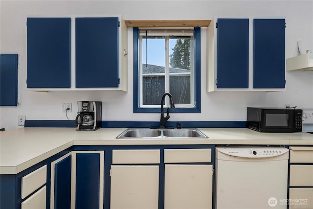 kitchen featuring black microwave, dishwasher, blue cabinetry, and a sink