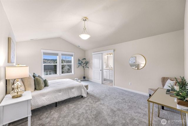 bedroom with lofted ceiling, baseboards, carpet flooring, and ensuite bathroom