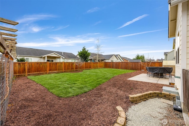 view of yard featuring a fenced backyard, a residential view, and a patio