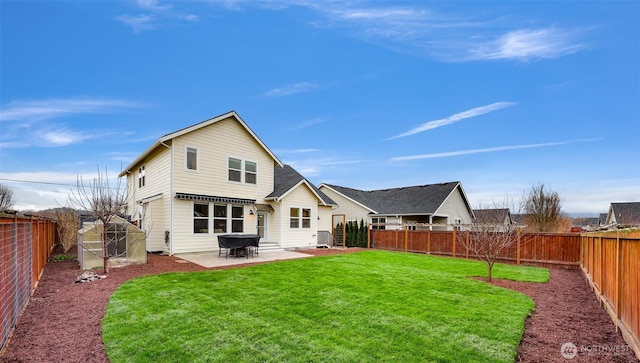 back of house featuring a yard, a patio area, and a fenced backyard