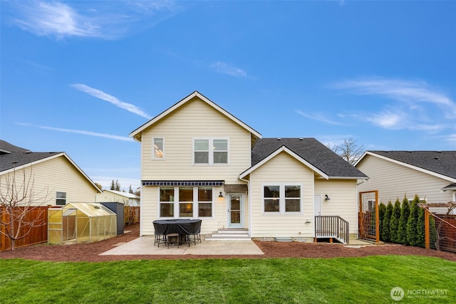 back of property featuring an exterior structure, a fenced backyard, an outdoor structure, and a patio