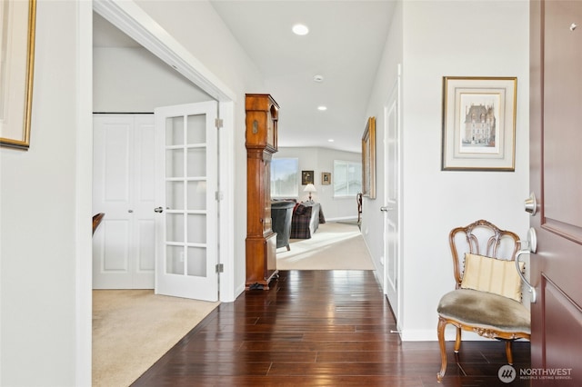 hallway with carpet flooring, wood finished floors, and recessed lighting